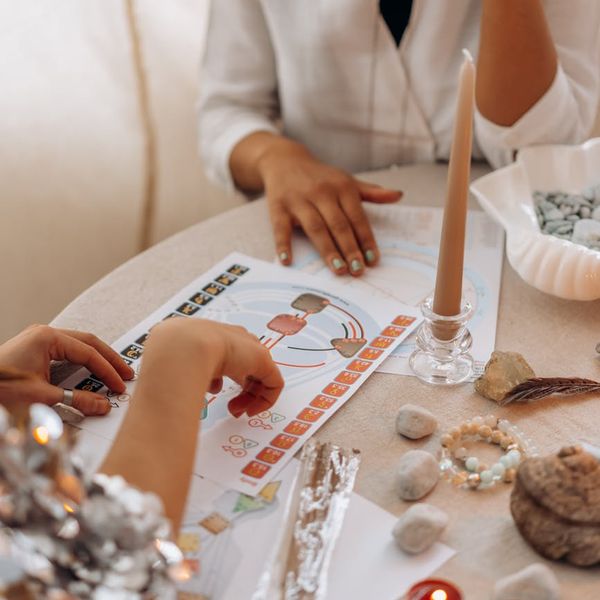 Woman sitting in a lotus yoga pose, radiating calm energy.